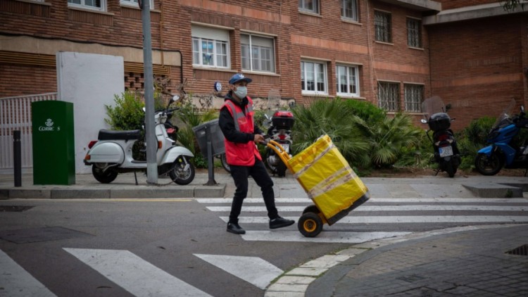 Un repartidor protegit amb mascareta treballa durant el període d'estat d'alarma. Europa Press